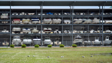 A boat storage facility includes four stories of boats that are exposed to the outside elements.